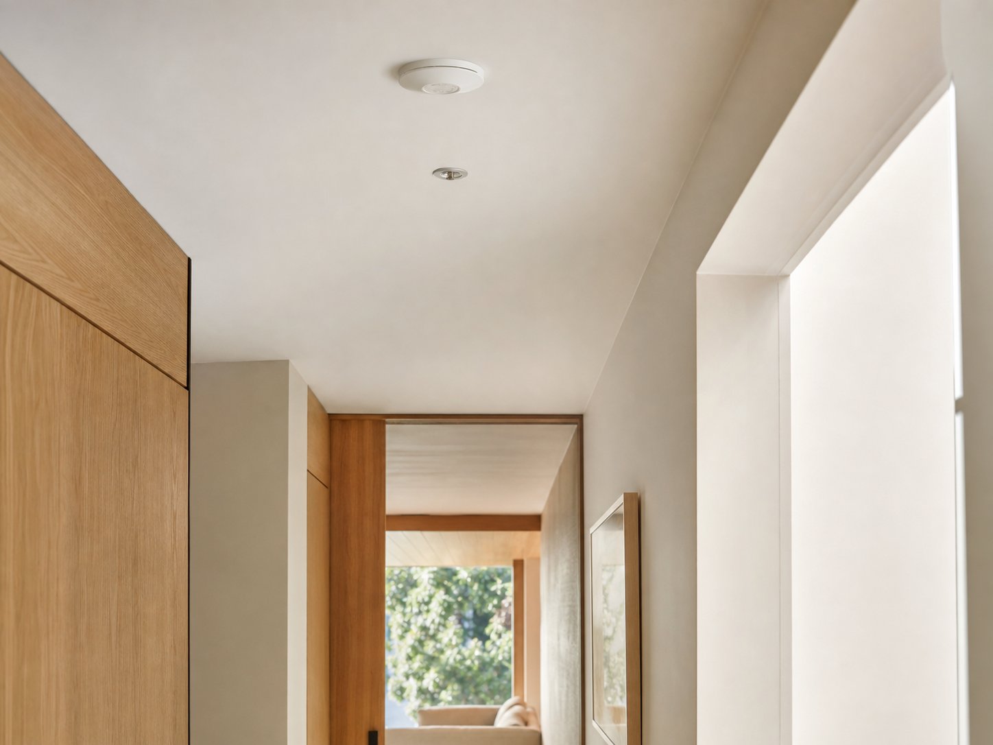 Low-profile residential smoke and heat detection sensor integrated into a modern ceiling